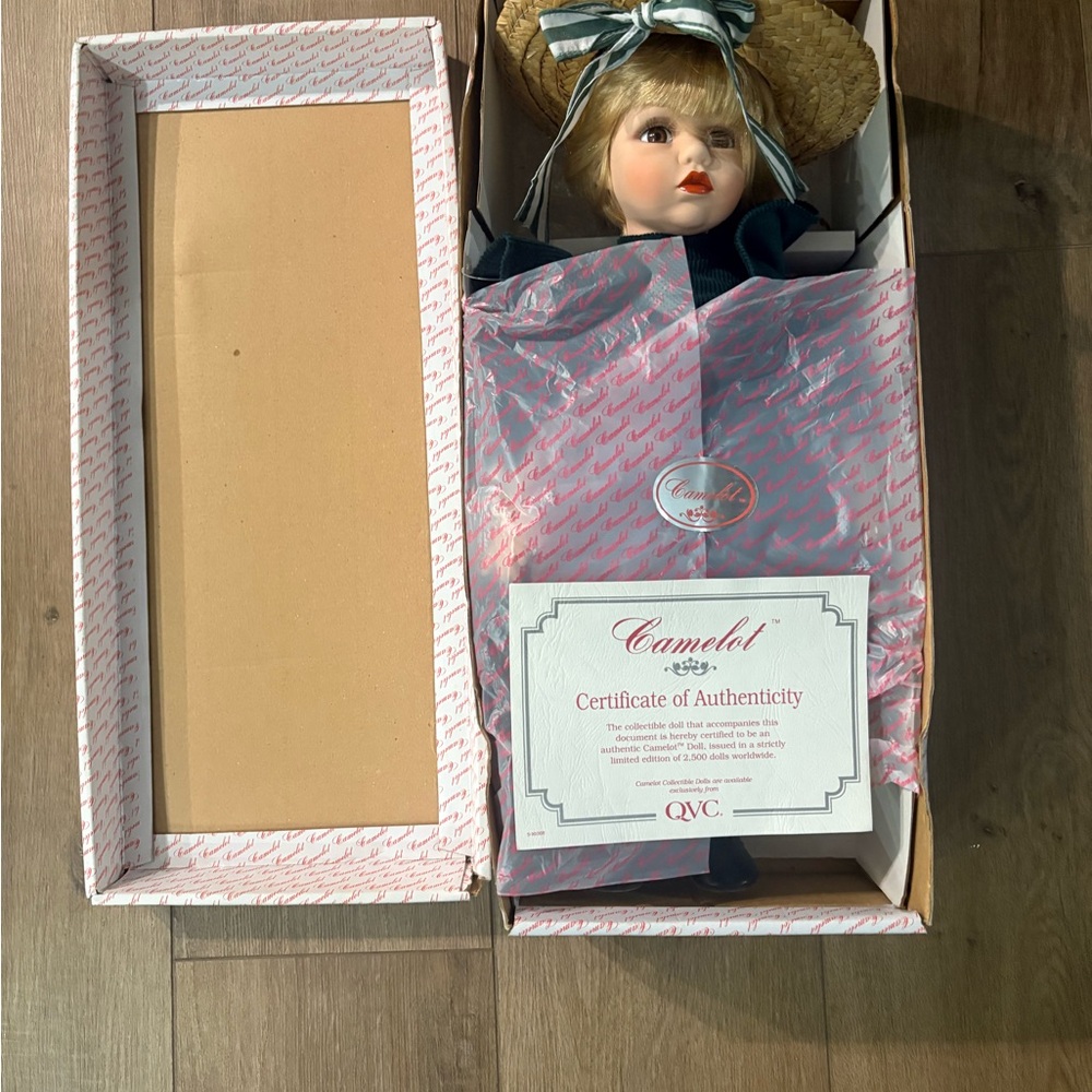 Camelot Collectible Porcelain Doll with Emerald Outfit and straw Hat with bow.